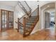 Hallway with terra cotta tile floors, staircase, and charming doors at 2975 E Wesley Ave, Denver, CO 80210