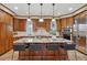 Spacious kitchen with a large granite island, dark wood cabinetry, and tile flooring at 2975 E Wesley Ave, Denver, CO 80210