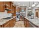 Close-up of the kitchen with stainless steel appliances and granite countertops and tile floors at 2975 E Wesley Ave, Denver, CO 80210