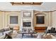 Bright living room with fireplace, coffered ceiling, and hardwood floors at 2975 E Wesley Ave, Denver, CO 80210