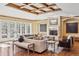 Bright living room features a fireplace, coffered ceiling, and French doors to the outdoors at 2975 E Wesley Ave, Denver, CO 80210