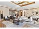 Open-concept living room with hardwood floors, neutral decor and coffered ceiling at 2975 E Wesley Ave, Denver, CO 80210