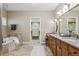 Spacious main bathroom with double vanity, marble counters and a walk-in closet at 2975 E Wesley Ave, Denver, CO 80210