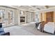 Bright main bedroom featuring a fireplace and French doors for ample natural light at 2975 E Wesley Ave, Denver, CO 80210