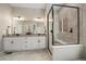Double vanity bathroom with a large walk-in shower and granite countertops at 672 W 128Th Pl, Westminster, CO 80234
