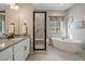 Elegant bathroom with soaking tub, shower, and granite vanity at 672 W 128Th Pl, Westminster, CO 80234