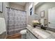 Clean bathroom with shower/tub combo, granite vanity, and updated fixtures at 672 W 128Th Pl, Westminster, CO 80234