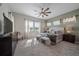 Main bedroom with a king-size bed, ample natural light, and ceiling fan at 672 W 128Th Pl, Westminster, CO 80234