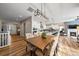 Open-concept dining area connected to a modern kitchen, living room, and bright, natural light at 672 W 128Th Pl, Westminster, CO 80234