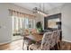 Dining area with stylish chairs and a modern light fixture, adjacent to the patio at 672 W 128Th Pl, Westminster, CO 80234