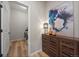 Inviting hallway with storage cabinet and modern artwork at 672 W 128Th Pl, Westminster, CO 80234