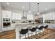 Island kitchen with granite countertops, stainless steel appliances, and white cabinets at 672 W 128Th Pl, Westminster, CO 80234