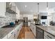 Spacious kitchen featuring granite countertops, stainless steel appliances, and white cabinetry at 672 W 128Th Pl, Westminster, CO 80234