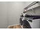 Bright laundry room with washer, dryer, and ample shelf space at 672 W 128Th Pl, Westminster, CO 80234