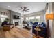 Bright living room with a cozy fireplace, large windows, and comfortable seating at 672 W 128Th Pl, Westminster, CO 80234