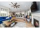 Cozy living room with a fireplace, seamlessly connected to the kitchen and dining areas at 672 W 128Th Pl, Westminster, CO 80234