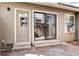 Cozy back patio with sliding glass door, standard door, and space for outdoor seating at 4634 S Fraser Ct # F, Aurora, CO 80015