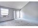 Bedroom with neutral carpet, a window AC unit, and sliding glass doors to the patio at 4634 S Fraser Ct # F, Aurora, CO 80015