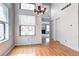 Dining room features hardwood floors, natural light, a chandelier, and an open layout leading to the living room at 4634 S Fraser Ct # F, Aurora, CO 80015