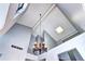 View of the foyer with vaulted ceilings, a skylight, and a hanging candle chandelier at 4634 S Fraser Ct # F, Aurora, CO 80015