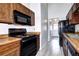 Classic kitchen features wood cabinets, appliances, and tile flooring with a door to the laundry room at 4634 S Fraser Ct # F, Aurora, CO 80015