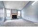 Bright living room with a fireplace, two windows and soft gray carpet at 4634 S Fraser Ct # F, Aurora, CO 80015