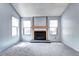 Bright living room with a fireplace, two windows and soft gray carpet at 4634 S Fraser Ct # F, Aurora, CO 80015
