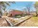Landscaped backyard with patio and pergola, garden, mature trees, and brick exterior at 6101 E 3Rd Ave, Denver, CO 80220