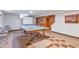 Finished basement with ping pong table, projector screen, built in bookshelf and checkered flooring at 6101 E 3Rd Ave, Denver, CO 80220