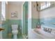 Charming bathroom featuring colorful tiling, shower, toilet, sink with vanity, and chrome fixtures at 6101 E 3Rd Ave, Denver, CO 80220