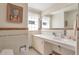 Bathroom featuring classic tiled walls, a built-in vanity, and abundant natural light from glass block windows at 6101 E 3Rd Ave, Denver, CO 80220