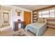 Cozy bedroom with carpet, a built-in desk and shelving, and ample natural light at 6101 E 3Rd Ave, Denver, CO 80220