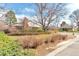 Well-manicured front yard with a brick single Gathering home, established landscaping, and mature trees at 6101 E 3Rd Ave, Denver, CO 80220