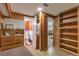 Hallway with full size bookshelf, hall closet, and access to bathroom and bonus space at 6101 E 3Rd Ave, Denver, CO 80220