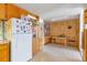 Bright, eat-in kitchen features wooden cabinets and a cozy breakfast nook with wood paneling at 6101 E 3Rd Ave, Denver, CO 80220