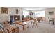 Spacious living room with a fireplace, plush carpeting, and an array of stylish mid-century modern furniture at 6101 E 3Rd Ave, Denver, CO 80220