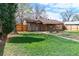 Expansive backyard featuring a lush lawn and mature trees, perfect for outdoor activities at 4250 Marshall St, Wheat Ridge, CO 80033