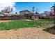 A spacious backyard with grass and mulch, surrounded by wood fences at 4250 Marshall St, Wheat Ridge, CO 80033