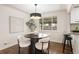 Dining room features a stylish table, modern light fixture, and easy access to kitchen at 4250 Marshall St, Wheat Ridge, CO 80033