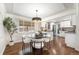 Bright dining room featuring hardwood floors, modern lighting, and a view to the kitchen at 4250 Marshall St, Wheat Ridge, CO 80033