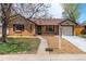 Charming brick ranch-style home features a well-manicured front yard and an attached garage at 4250 Marshall St, Wheat Ridge, CO 80033