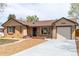 Lovely ranch-style home boasts a brick exterior, large picture window, and attached garage at 4250 Marshall St, Wheat Ridge, CO 80033
