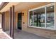 Inviting front porch with brick pillars, security door, and a large picture window at 4250 Marshall St, Wheat Ridge, CO 80033