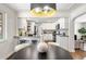 Bright open kitchen and dining area, modern lighting, and white cabinets at 4250 Marshall St, Wheat Ridge, CO 80033