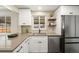 Well-lit kitchen features open shelving, stainless steel appliances, and gray counters at 4250 Marshall St, Wheat Ridge, CO 80033