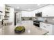 Spacious kitchen boasts white cabinets, gray counters, and updated appliances at 4250 Marshall St, Wheat Ridge, CO 80033