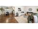 Bright living room with hardwood floors, modern decor, and an open layout to the dining area at 4250 Marshall St, Wheat Ridge, CO 80033