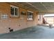 Covered patio area featuring brick walls, windows, and a concrete floor, perfect for outdoor gatherings at 4250 Marshall St, Wheat Ridge, CO 80033