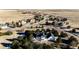 Aerial view showcases this suburban home's mature trees and surrounding community at 935 Green Gables Cir, Bennett, CO 80102