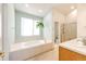Bright bathroom featuring a soaking tub, double sinks, and a separate shower, providing a spa-like experience at 935 Green Gables Cir, Bennett, CO 80102